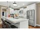 Bright white kitchen with a large island, stainless steel appliances, and a view of the cooktop at 6444 Kit Creek Rd, Morrisville, NC 27560