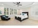 Spacious main bedroom featuring a tray ceiling, plantation shutters, and neutral carpet at 6444 Kit Creek Rd, Morrisville, NC 27560