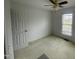 Cozy bedroom with neutral walls, a ceiling fan and single window at 65 Opie Frazier Rd, Henderson, NC 27537