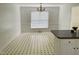 Sunlit dining area featuring neutral walls and a patterned tile floor at 65 Opie Frazier Rd, Henderson, NC 27537