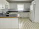 Bright kitchen with white cabinets, contrasting countertops, and an eat-in island at 65 Opie Frazier Rd, Henderson, NC 27537