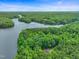 Breathtaking aerial view of the property, nestled within a lush forest near the water at 657 Lakeview Dr, Stem, NC 27581