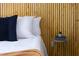 Close-up of a bedroom with a wooden accent wall and modern side table decor at 657 Lakeview Dr, Stem, NC 27581
