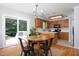 Bright dining area with a round table, chairs, and access to the deck at 657 Lakeview Dr, Stem, NC 27581