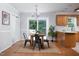 Charming dining area with wood table, pendant lighting, and sliding glass doors at 657 Lakeview Dr, Stem, NC 27581