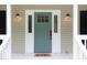 Close-up of a stylish front door with sidelights and a doormat, enhancing the home's curb appeal at 657 Lakeview Dr, Stem, NC 27581