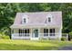 Charming two-story home featuring a quaint front porch and a well-maintained lawn at 657 Lakeview Dr, Stem, NC 27581