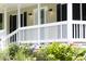 Charming front porch with flowers, offering a welcoming entrance with classic design and curb appeal at 657 Lakeview Dr, Stem, NC 27581