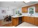 Open kitchen with wood cabinets, breakfast bar, and a dining area with sliding glass doors at 657 Lakeview Dr, Stem, NC 27581