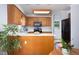 Spacious kitchen with stainless steel appliances, wood cabinets, island, and breakfast bar at 657 Lakeview Dr, Stem, NC 27581