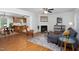 Cozy living room with a fireplace, hardwood floors, and comfortable seating at 657 Lakeview Dr, Stem, NC 27581