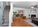 Open living room featuring hardwood floors, a fireplace, and staircase access at 657 Lakeview Dr, Stem, NC 27581