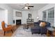 Living room filled with natural light, a fireplace, and comfortable seating at 657 Lakeview Dr, Stem, NC 27581