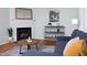 Living room featuring a fireplace, modern shelving, and stylish decor at 657 Lakeview Dr, Stem, NC 27581