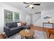 Well-lit living room with hardwood floors and a large window at 657 Lakeview Dr, Stem, NC 27581