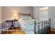 Inviting bedroom featuring wood floors, a decorative bed frame, and ample natural light, ideal for relaxation at 69 Margaret Pl, Chapel Hill, NC 27516