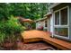 Inviting wooden deck with outdoor seating, surrounded by lush greenery and trees at 69 Margaret Pl, Chapel Hill, NC 27516