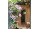 Charming wooden sauna entrance surrounded by lush pink rhododendrons, creating a tranquil spa-like setting at 69 Margaret Pl, Chapel Hill, NC 27516
