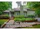 Inviting home exterior with lush landscaping, brick pathway and charming curb appeal - watch the video walkthrough now! at 69 Margaret Pl, Chapel Hill, NC 27516