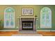 Cozy fireplace with decorative mantle between architectural windows, perfect for relaxation at 69 Margaret Pl, Chapel Hill, NC 27516