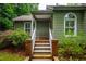 Inviting home entrance with white railings, beautiful landscaping, and a brick-lined walkway at 69 Margaret Pl, Chapel Hill, NC 27516