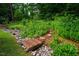 Tranquil garden with stone paths, vibrant plants, and lush greenery at 69 Margaret Pl, Chapel Hill, NC 27516