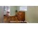 Well-lit hallway with hardwood floors, neutral tones, and ample space for furniture, blending comfort and style at 69 Margaret Pl, Chapel Hill, NC 27516