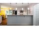 Bright kitchen with stainless steel appliances, stone countertops, and stylish pendant lighting over the breakfast bar at 69 Margaret Pl, Chapel Hill, NC 27516