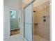 Bathroom shower featuring glass door and tiled surround at 69 Margaret Pl, Chapel Hill, NC 27516