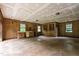 Unfinished basement with wood paneled walls, concrete floor and natural lighting at 6909 Hickory Dr, Raleigh, NC 27603