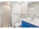 Bright bathroom featuring blue vanity, a shower and a white toilet at 6909 Hickory Dr, Raleigh, NC 27603