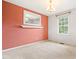 Dining area with peach accent wall and white carpet at 6909 Hickory Dr, Raleigh, NC 27603