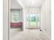 Bright entryway with white walls, carpeted flooring, and a glass front door allowing natural light at 6909 Hickory Dr, Raleigh, NC 27603