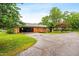 Brick house with back patio and garage with lush backyard at 6909 Hickory Dr, Raleigh, NC 27603