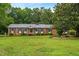 Charming brick home with well-maintained lawn, blue shutters, and a welcoming front porch at 6909 Hickory Dr, Raleigh, NC 27603