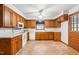 Functional kitchen featuring wooden cabinets, white appliances, and ample counter space at 6909 Hickory Dr, Raleigh, NC 27603