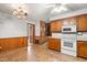 Bright eat-in kitchen with white appliances, light countertops, and wooden cabinets at 6909 Hickory Dr, Raleigh, NC 27603