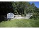 Well-maintained backyard featuring multiple storage sheds and a fenced-in area at 70 Glen Oaks Drive Dr, Youngsville, NC 27596