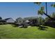 Spacious backyard featuring a patio, mature trees, and views of the home's exterior at 70 Glen Oaks Drive Dr, Youngsville, NC 27596