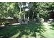 Serene backyard with a charming wooden swing set and a neatly maintained lawn at 70 Glen Oaks Drive Dr, Youngsville, NC 27596
