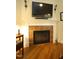 Close-up of a traditional fireplace with tile surround, hardwood flooring and white mantle at 70 Glen Oaks Drive Dr, Youngsville, NC 27596