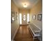 Bright and airy foyer with hardwood floors, decorative front door and bench seating at 70 Glen Oaks Drive Dr, Youngsville, NC 27596
