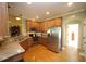 Well-lit kitchen featuring wood cabinets, granite countertops, and stainless steel appliances at 70 Glen Oaks Drive Dr, Youngsville, NC 27596