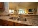 Kitchen counter featuring granite countertops, stainless steel sink, and view to the living room at 70 Glen Oaks Drive Dr, Youngsville, NC 27596