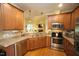 Modern kitchen with stainless steel appliances, granite countertops, and a view into the Gathering room at 70 Glen Oaks Drive Dr, Youngsville, NC 27596
