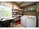 Bright laundry room featuring a washer, dryer, shelving, and window at 70 Glen Oaks Drive Dr, Youngsville, NC 27596