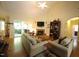 Spacious living room with hardwood floors, a cozy fireplace, and lots of natural light at 70 Glen Oaks Drive Dr, Youngsville, NC 27596
