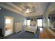This is a well-lit primary bedroom with a ceiling fan and trey ceilings at 70 Glen Oaks Drive Dr, Youngsville, NC 27596