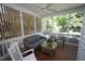Cozy screened patio with wood floors and comfortable furniture for relaxing outdoors at 70 Glen Oaks Drive Dr, Youngsville, NC 27596