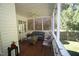 Well-lit screened patio with ample seating and views of the green backyard at 70 Glen Oaks Drive Dr, Youngsville, NC 27596